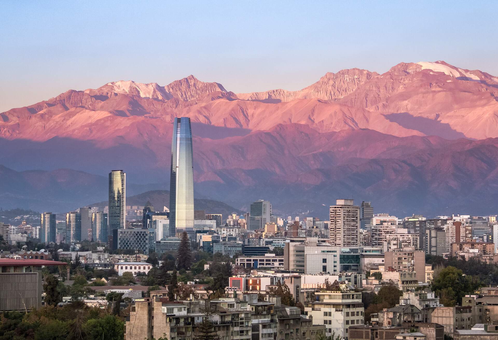 Aaerial view of Santiago skyline at sunset with Costanera skyscraper and Andes Mountains - Santiago, Chile
