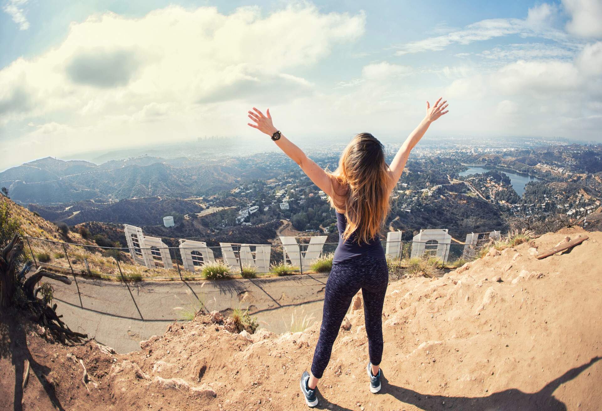 Young woman at the top of Hollywood, Los Angeles, California; Shutterstock ID 709428715; Purpose: Blog post - body image; Brand (KAYAK, Momondo, Any): Swoodoo
