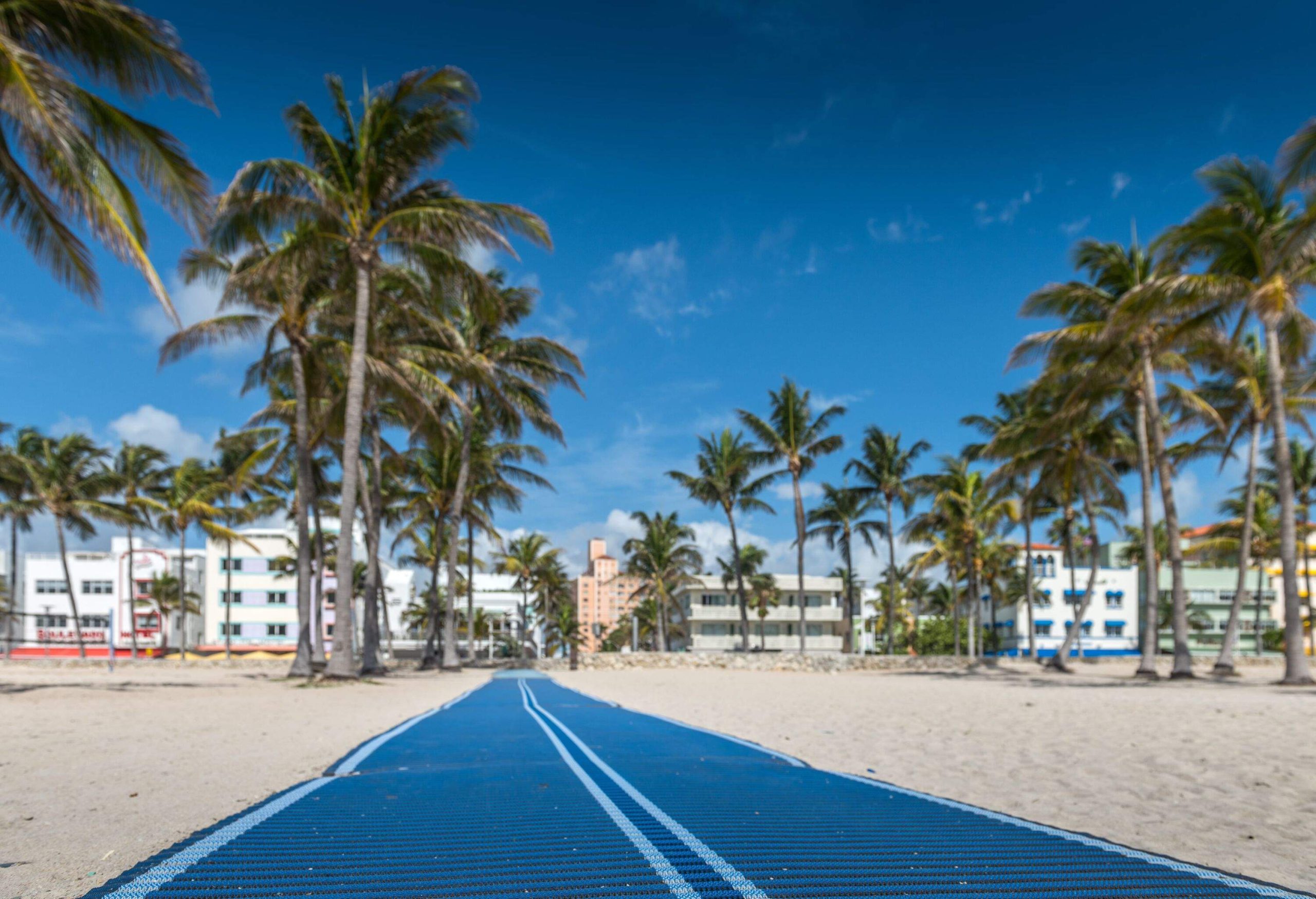 Blue pathway helping people with physical impairment going thru the beach sand.