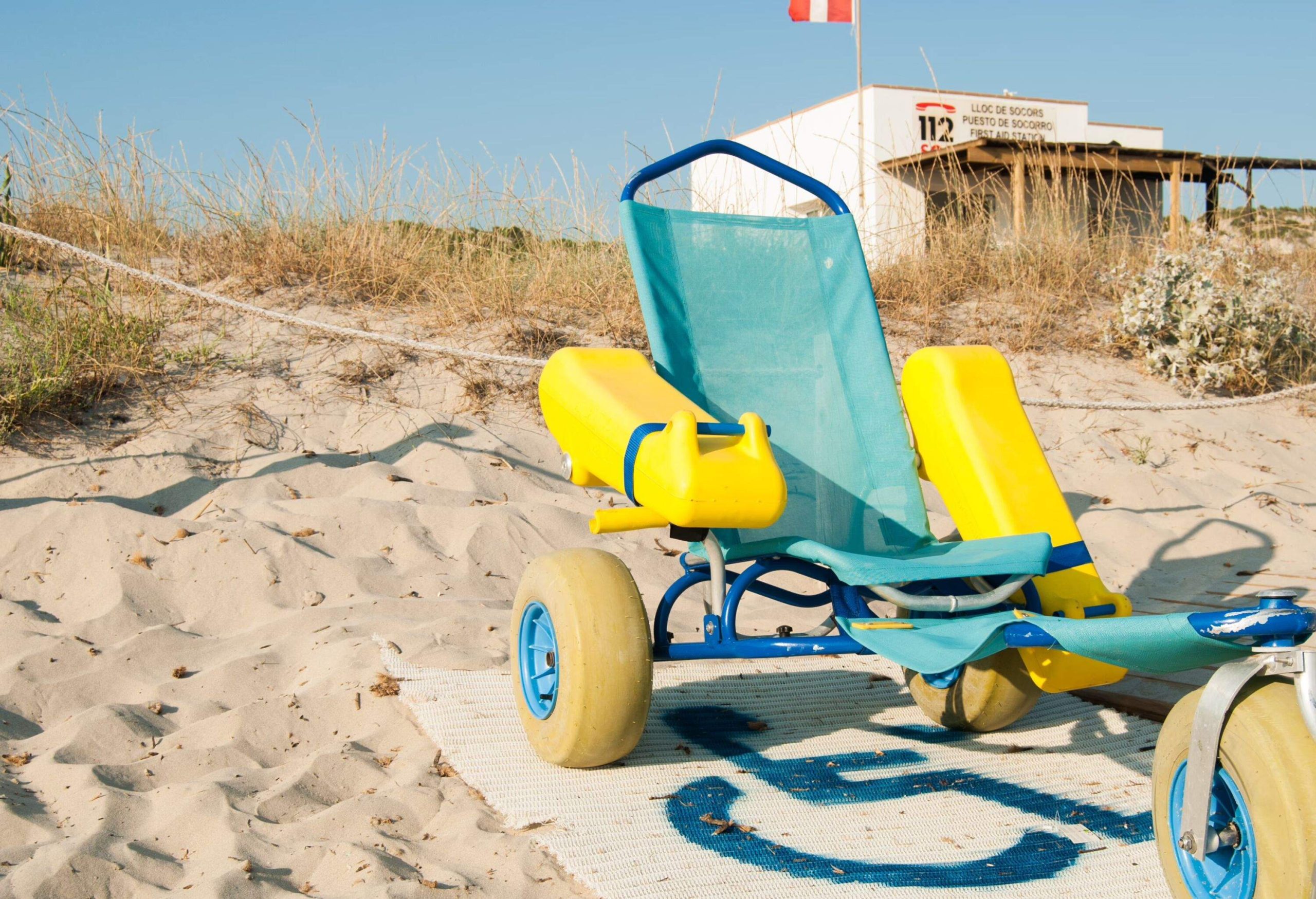 Wheelchair for the disabled and first aid station on the sandy beach