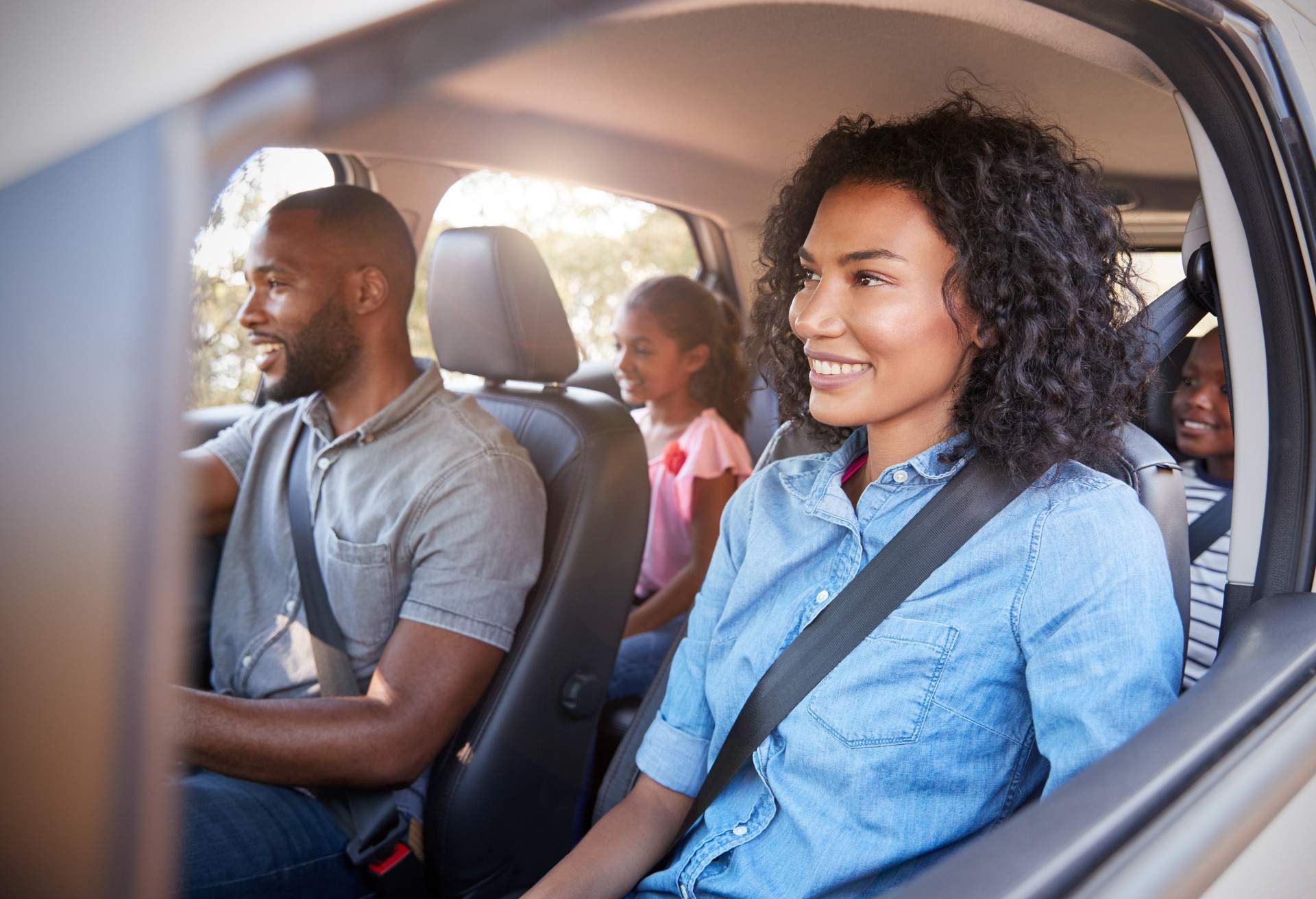 A family in a car, during a road trip