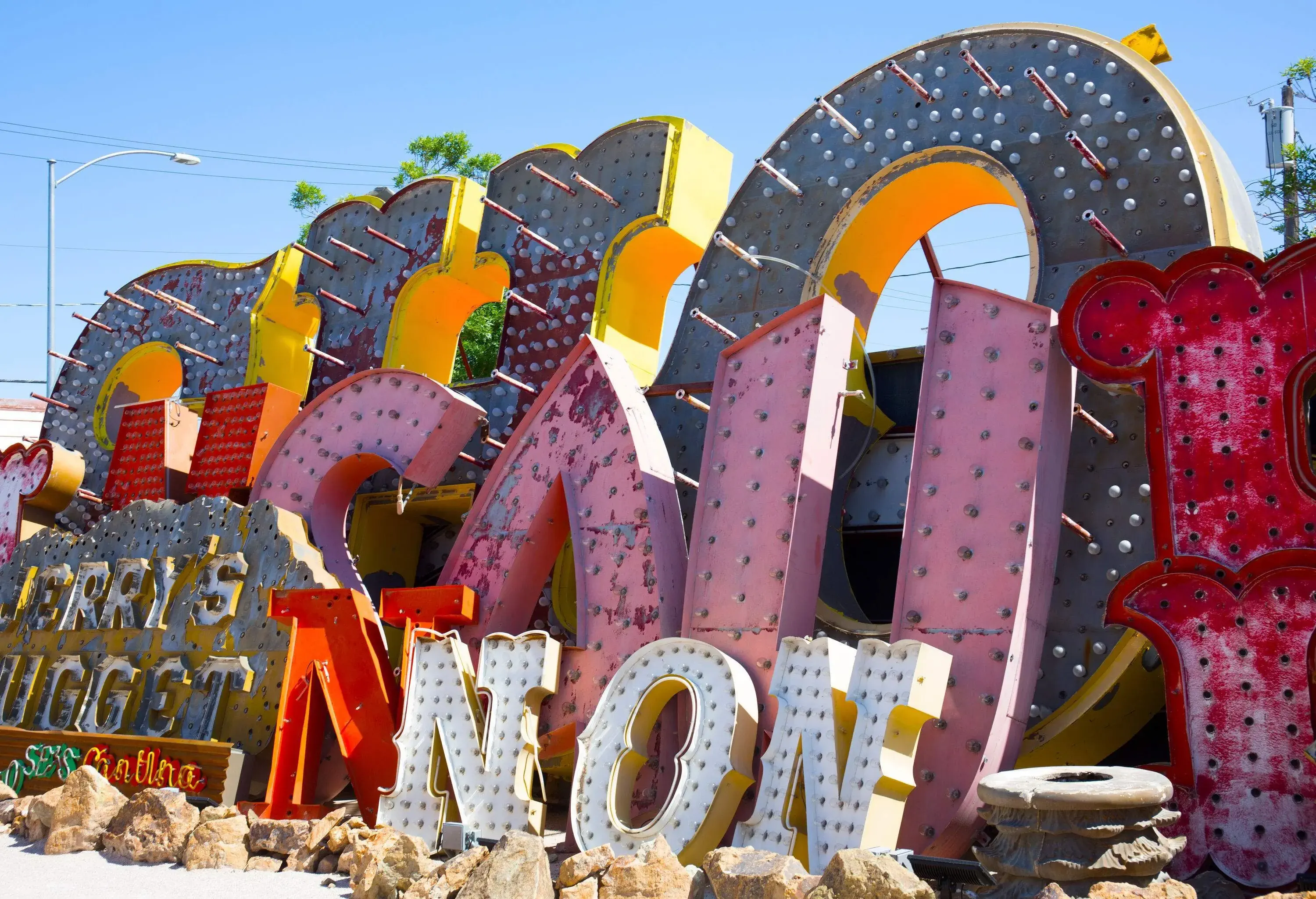 A jumble of marquee lettering and store signs along a debris path.