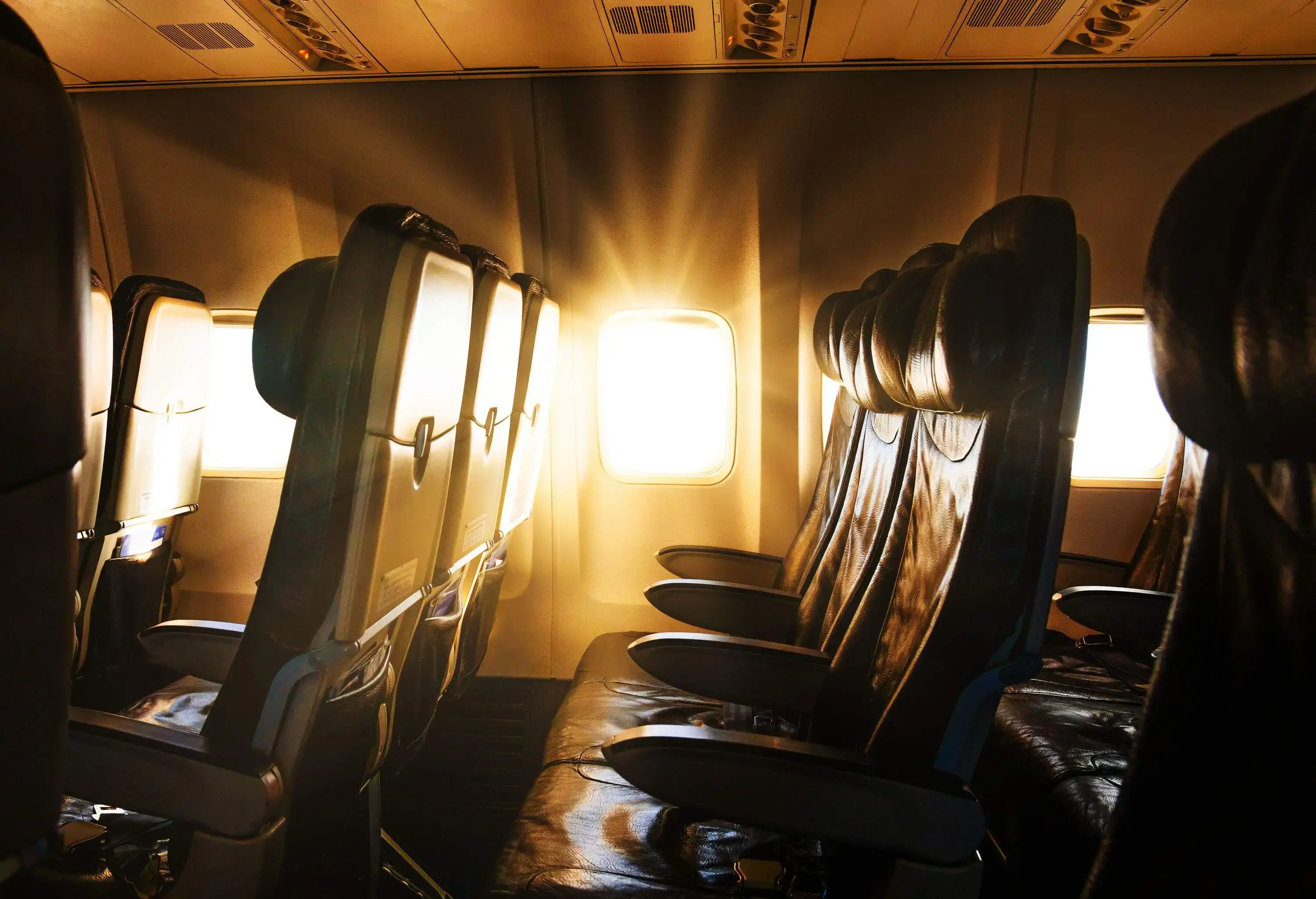 The piercing rays of the sun beaming through the airplane window.