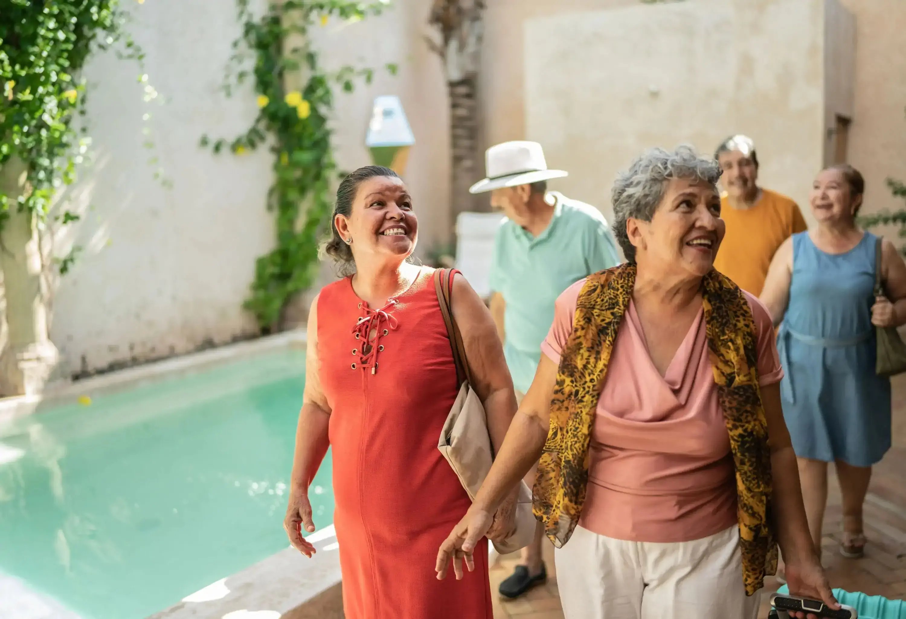 Group of senior friends talking while arriving to their accommodation