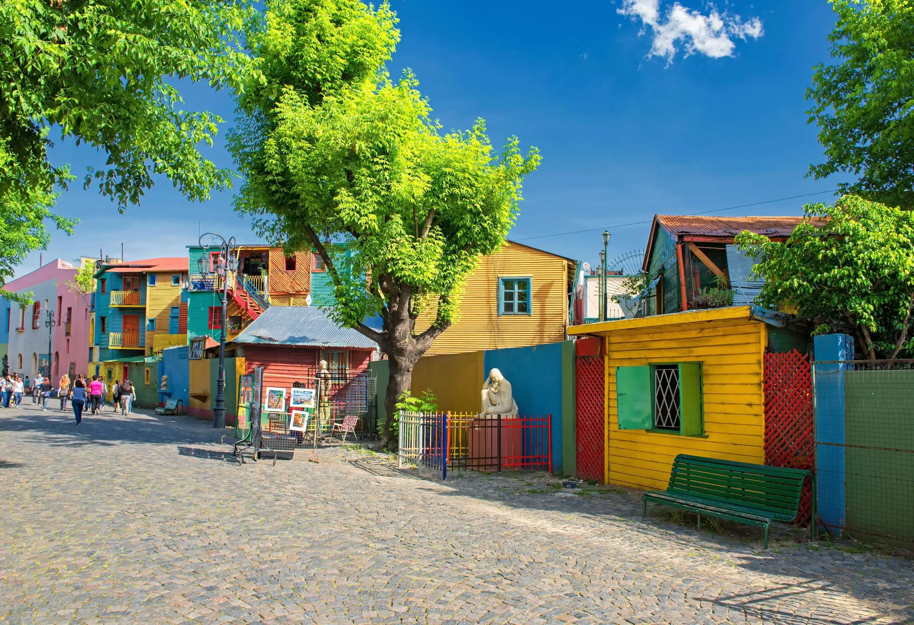 A lively neighbourhood with a delightful array of colourful houses adorning the street with their vibrant facades.