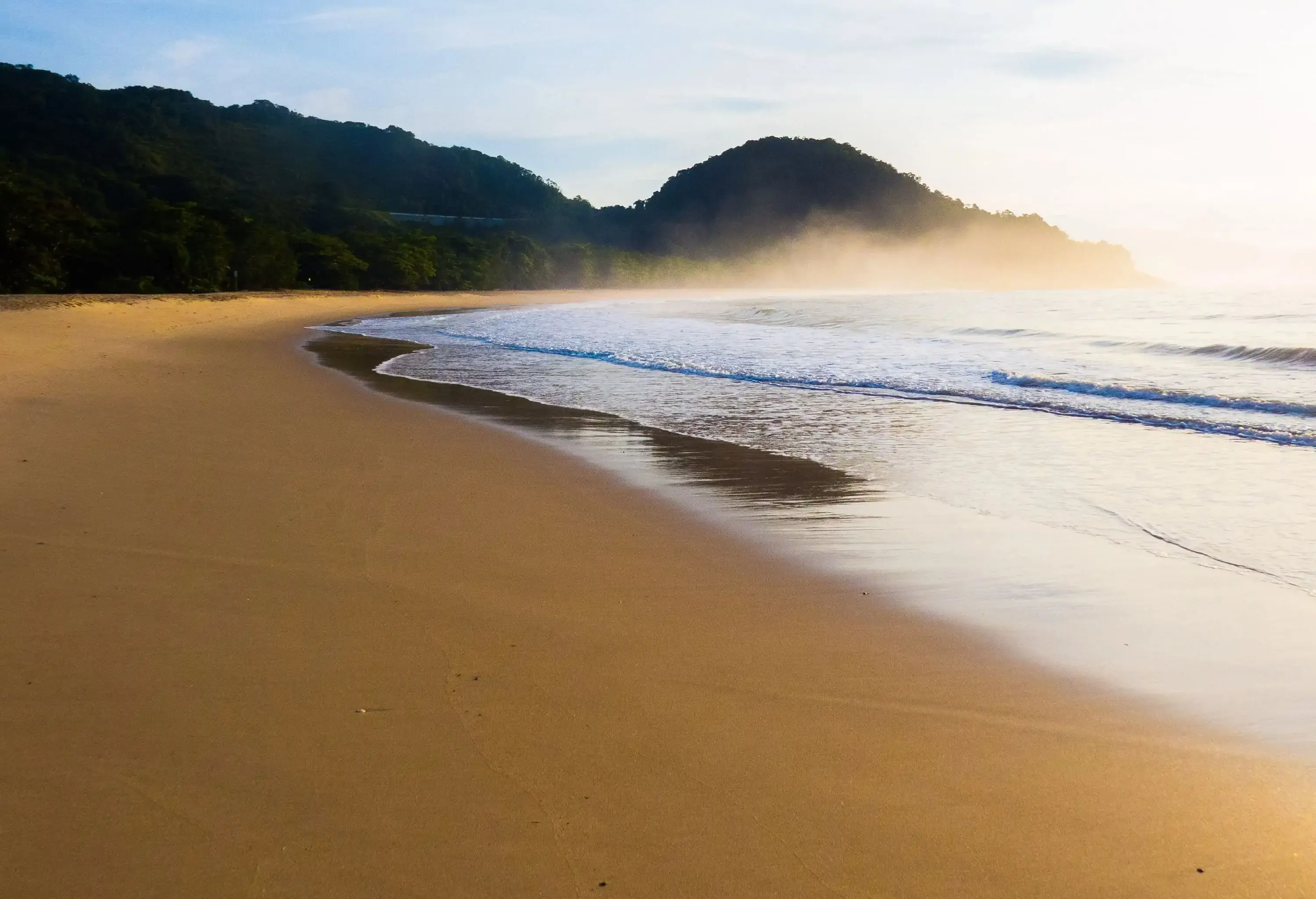 Low angle view of misty sandy beach after sunrise