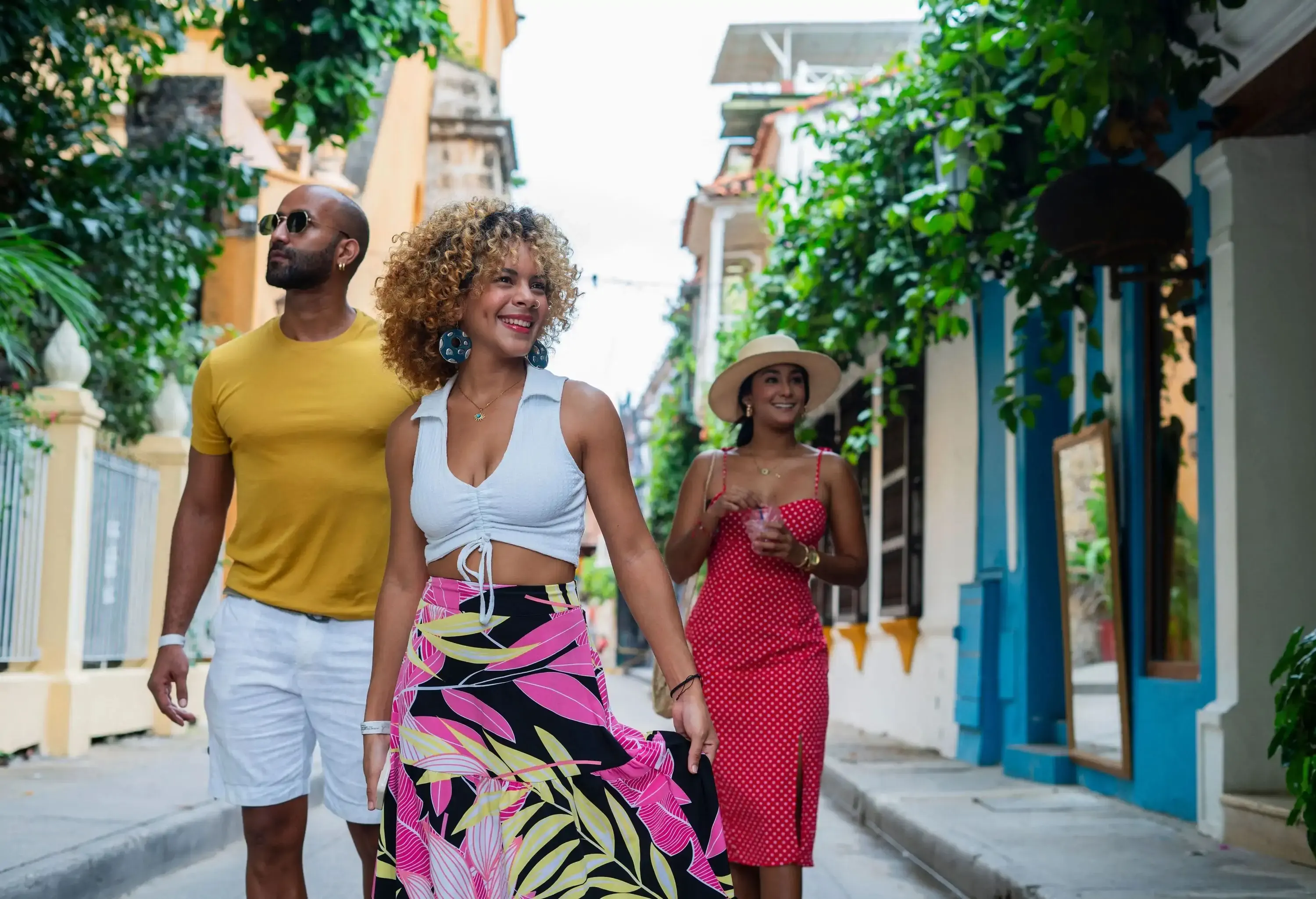 Group of Latin friends walk through the colonial streets of beautiful Cartagena de Indias while wearing their comfortable and cool outfits