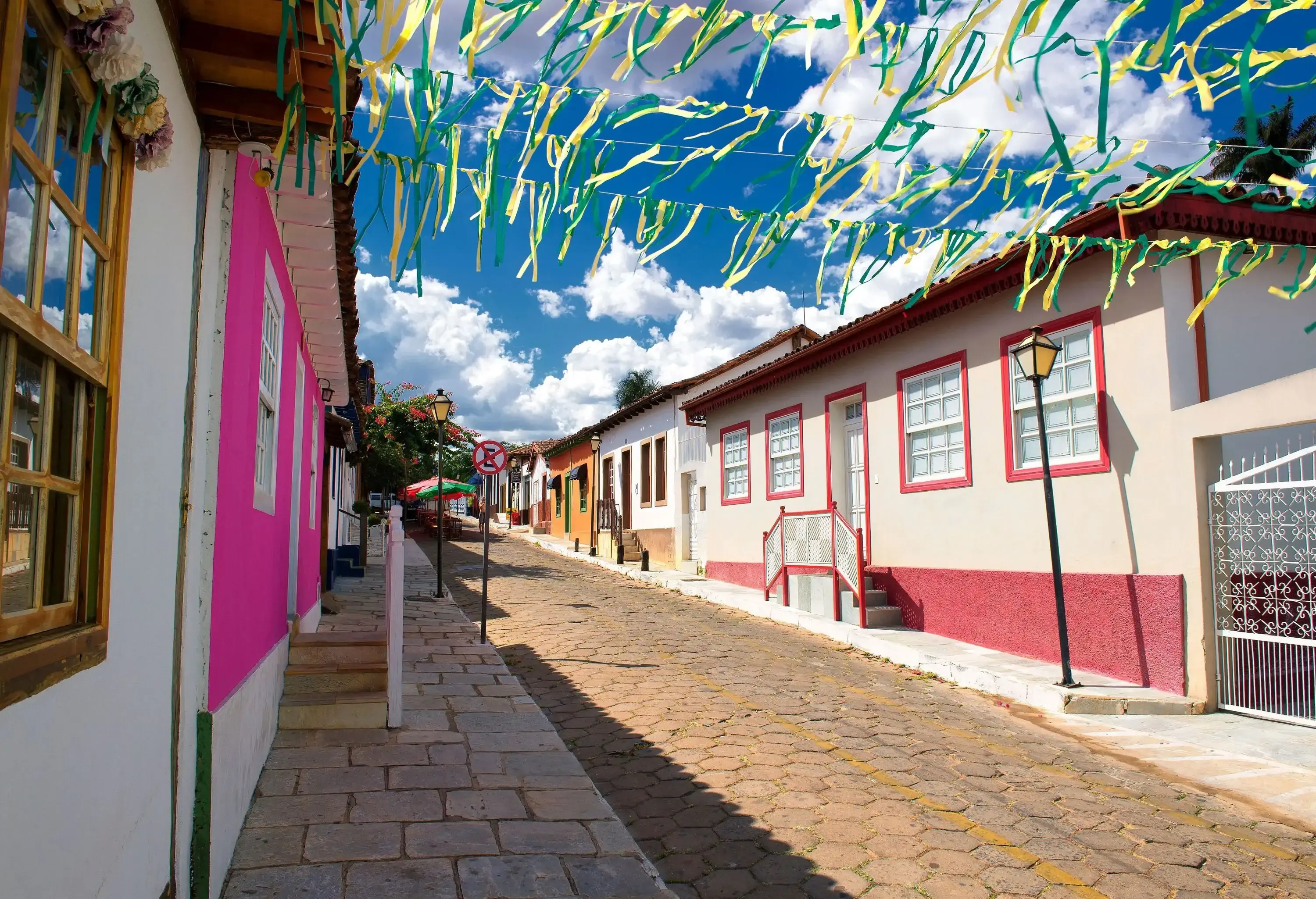 A neighbourhood street with festival banners bordered by residential homes.
