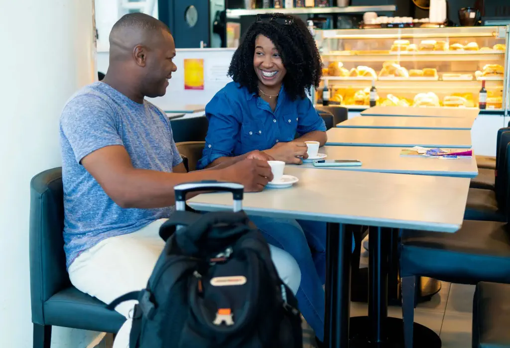 Couple sitting and talking in a cafe during their vacation
