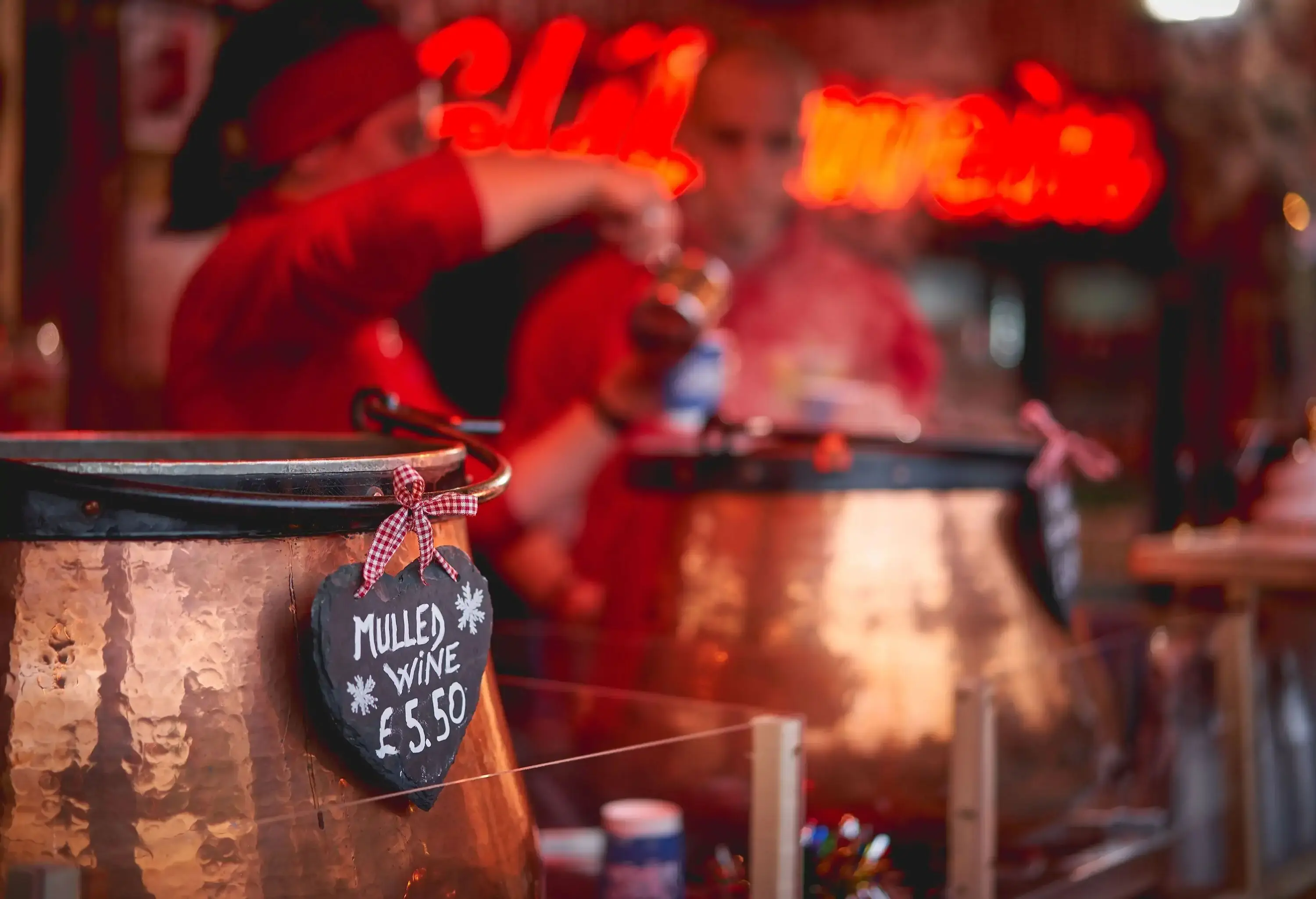 Pots of mulled wine in a stall in a Christmas market