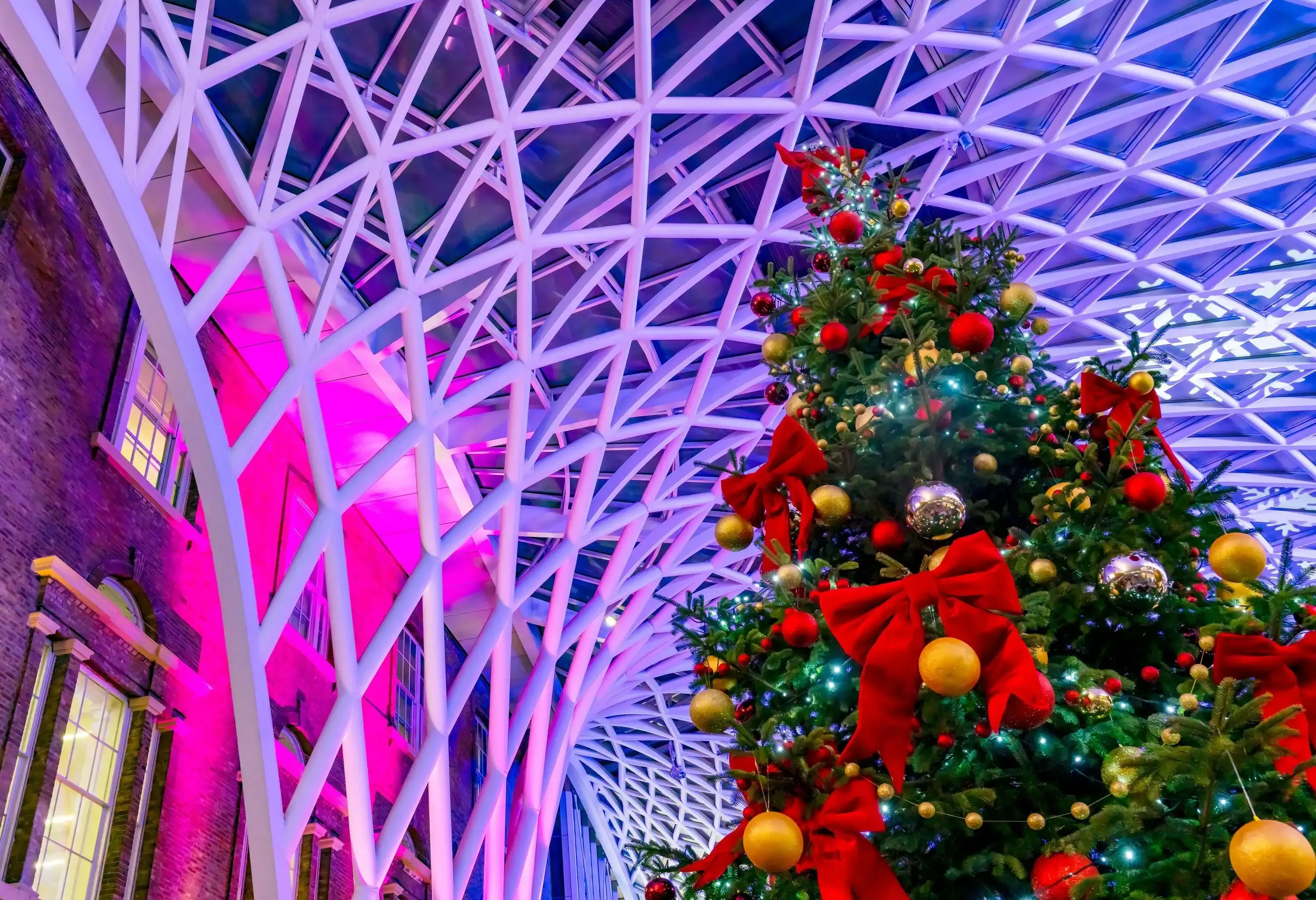 Low angle view of a Christmas tree by a metal structure