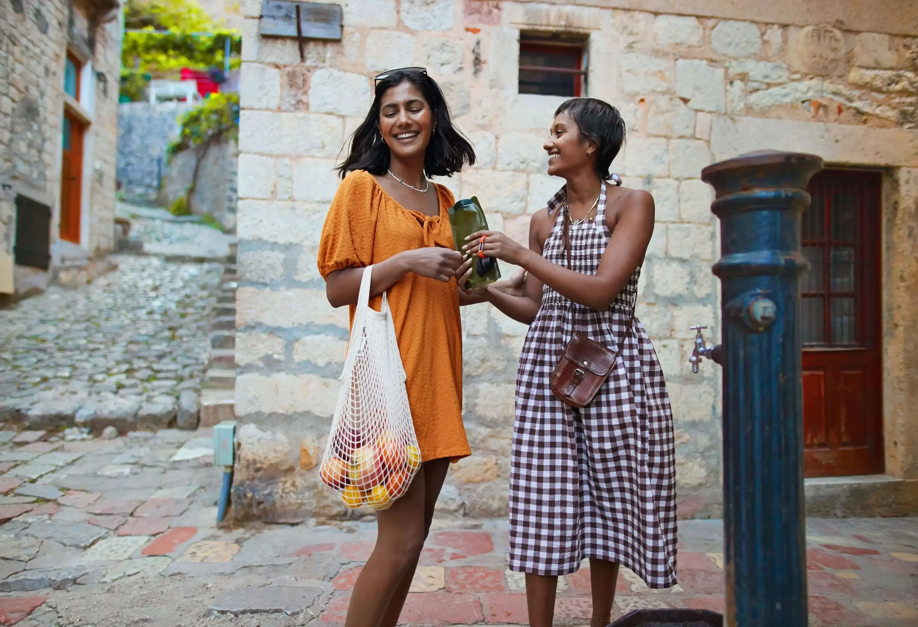 Two girlfriends with food shopping enjoying old town