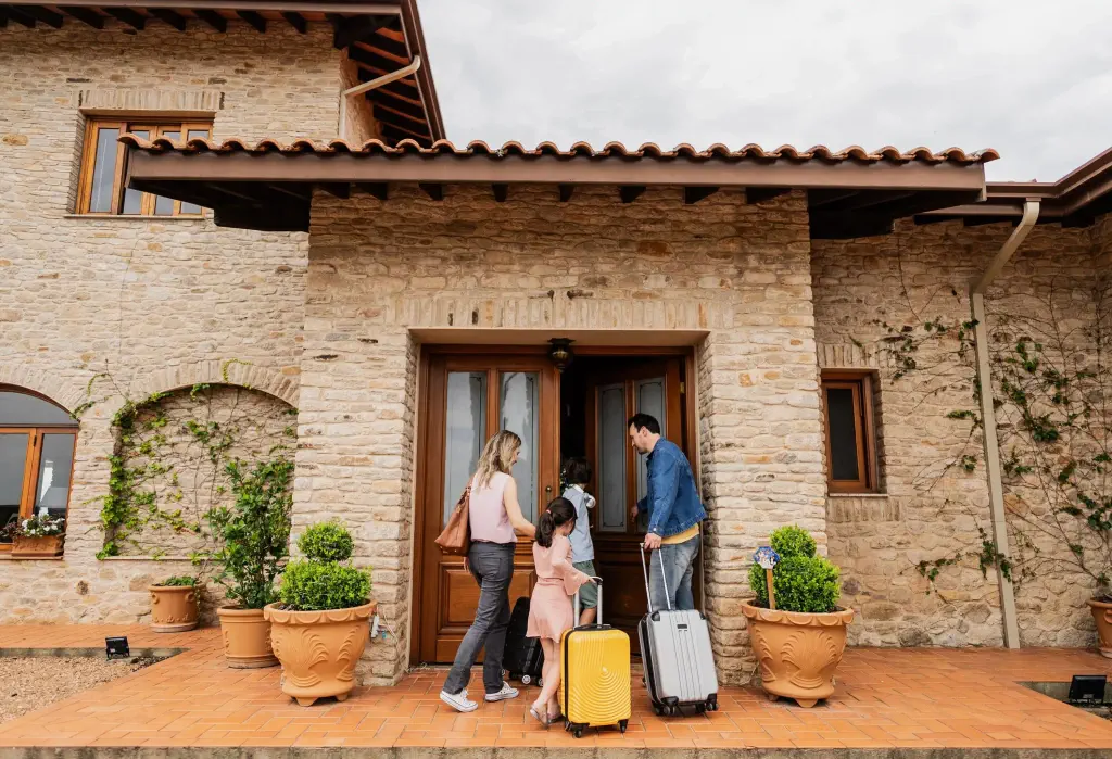 Family arriving at a farm house hotel