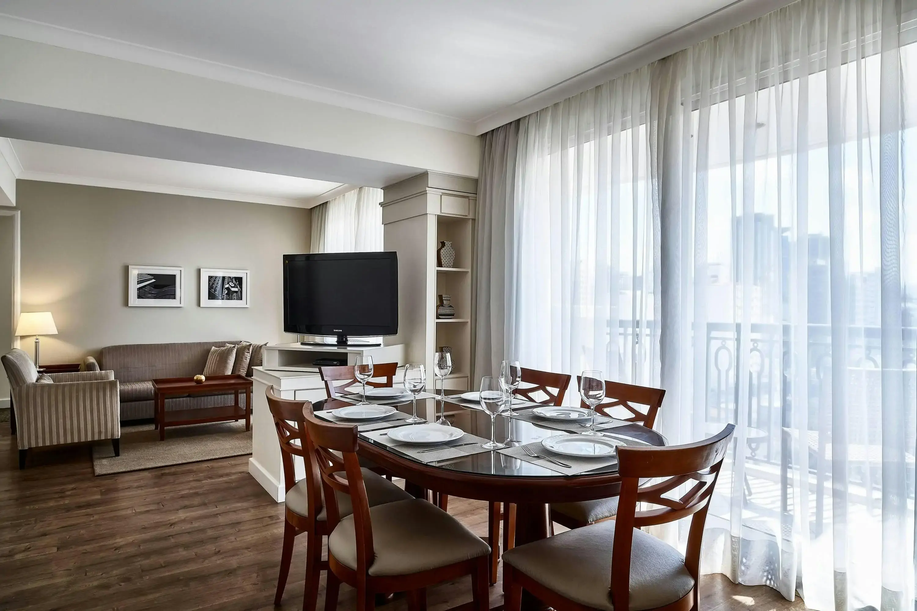 Elegant modern dining room with city view of a hotel suite
