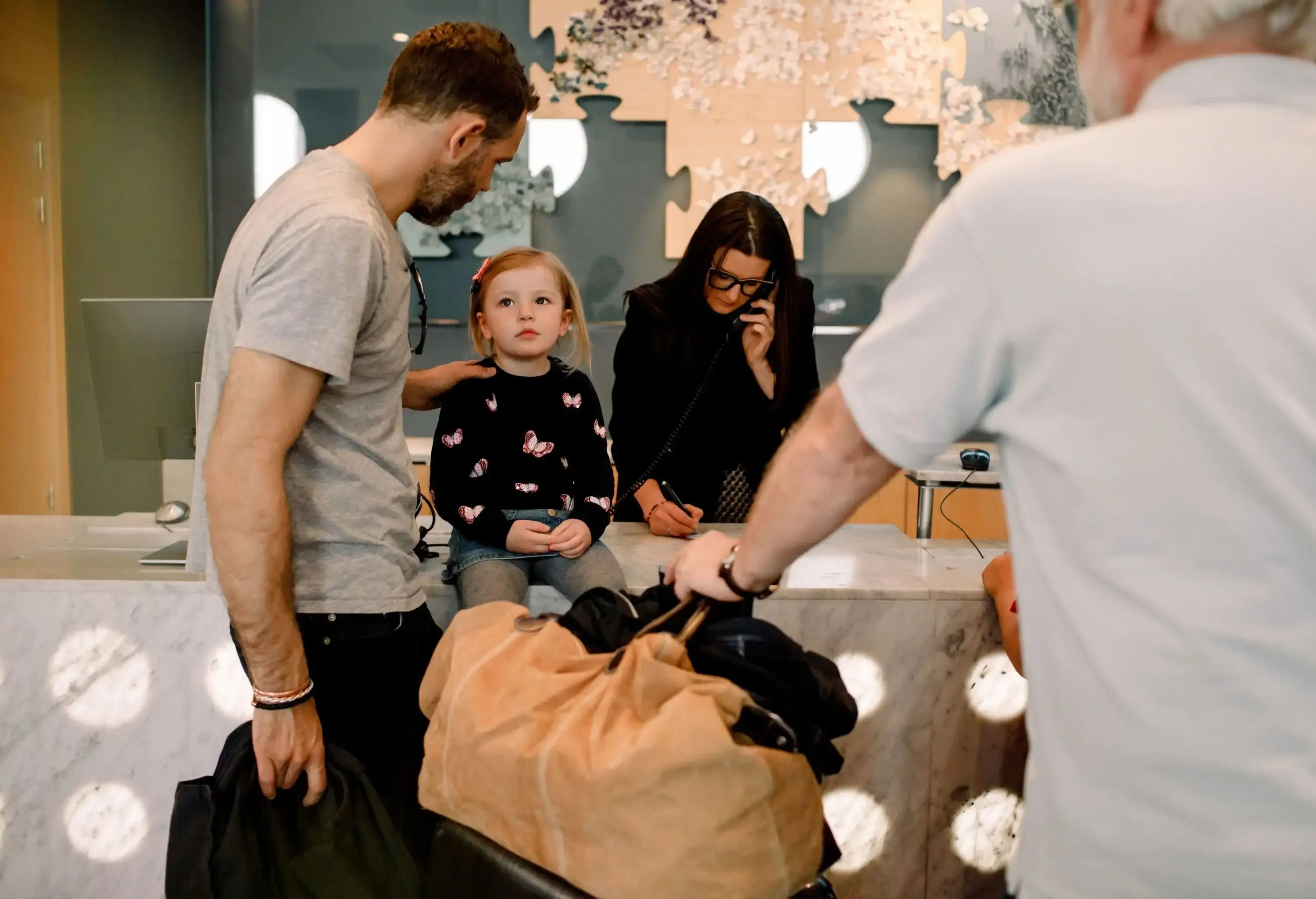 Family with small child at hotel reception