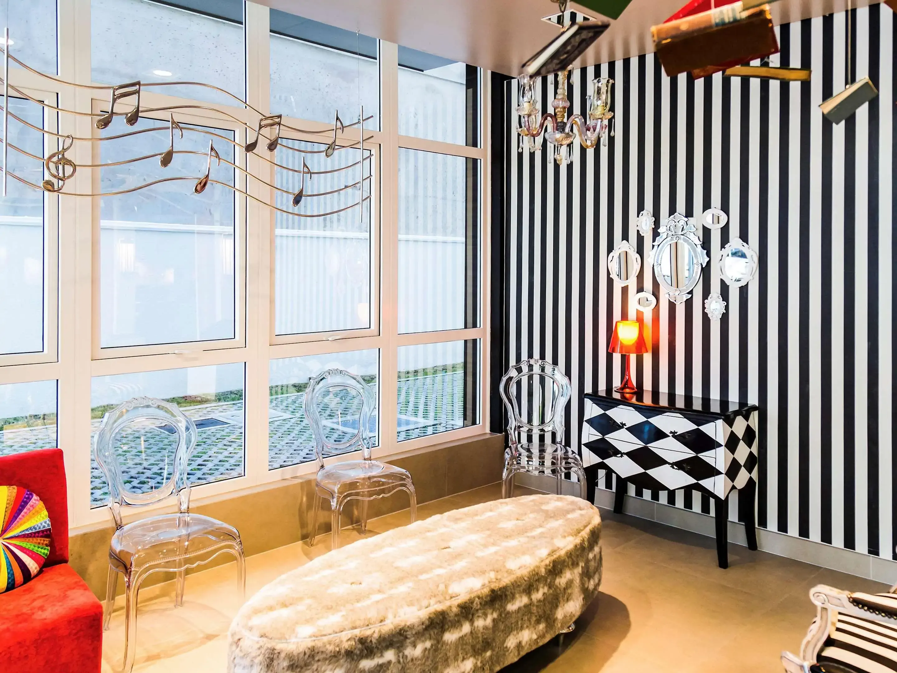 Eclectic hotel interior with black and white stripes and ghost chairs