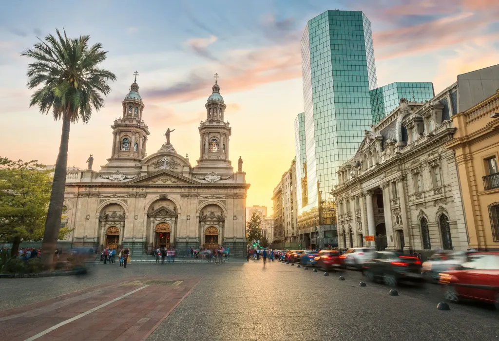 Cars and crowds come and go in the square, with its modern glass towers at the heart of its ornate neoclassical cathedral and historic central post office.