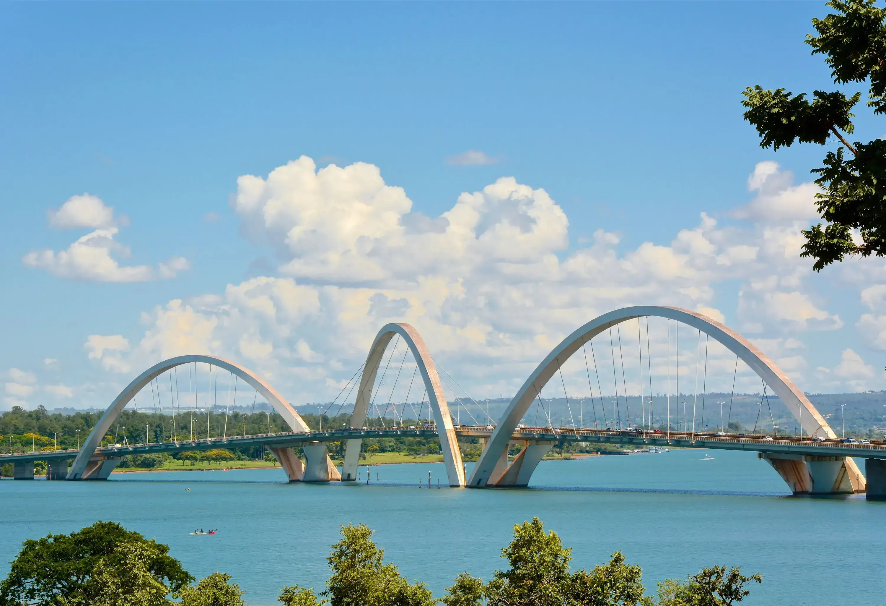 The two areas beside the lake are connected by a futuristic bridge with three asymmetrical steel arches that pass over it diagonally and are carried by steel cables alternately at each side of the deck.