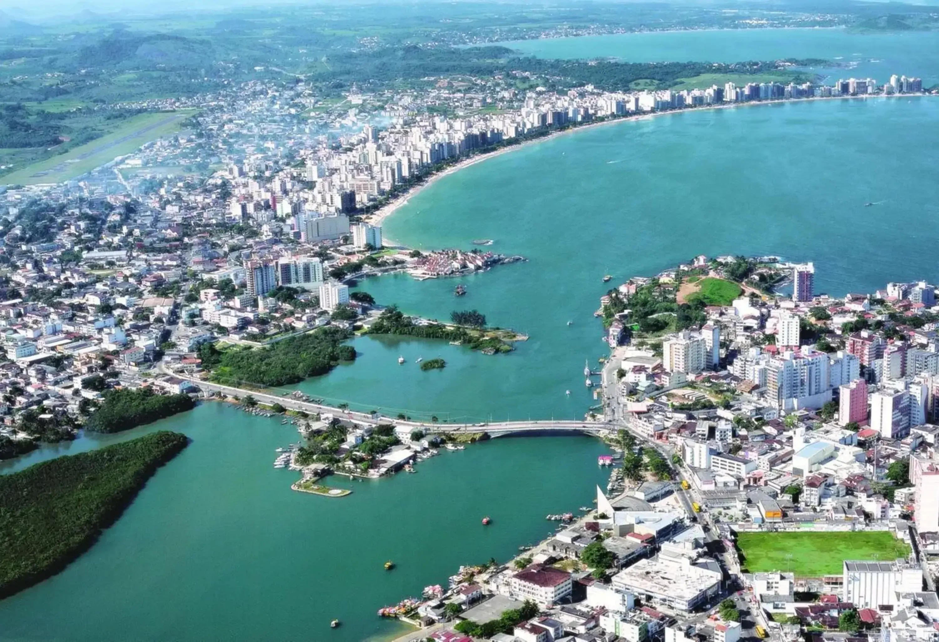 A stunning city by the coast, divided by a picturesque inlet and connected by a graceful bridge.