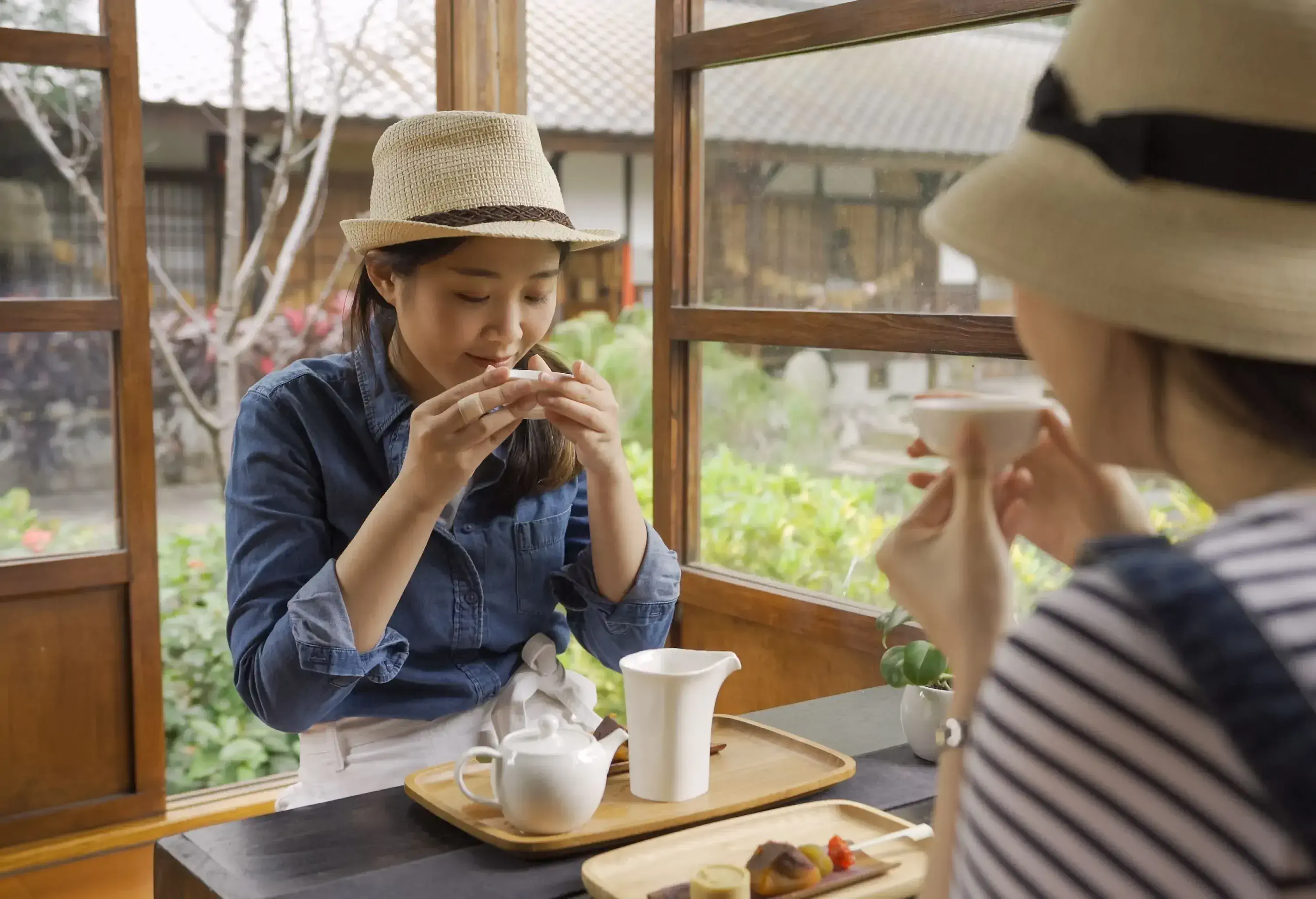 Two young women enjoy tea at a local Japanese cafe.