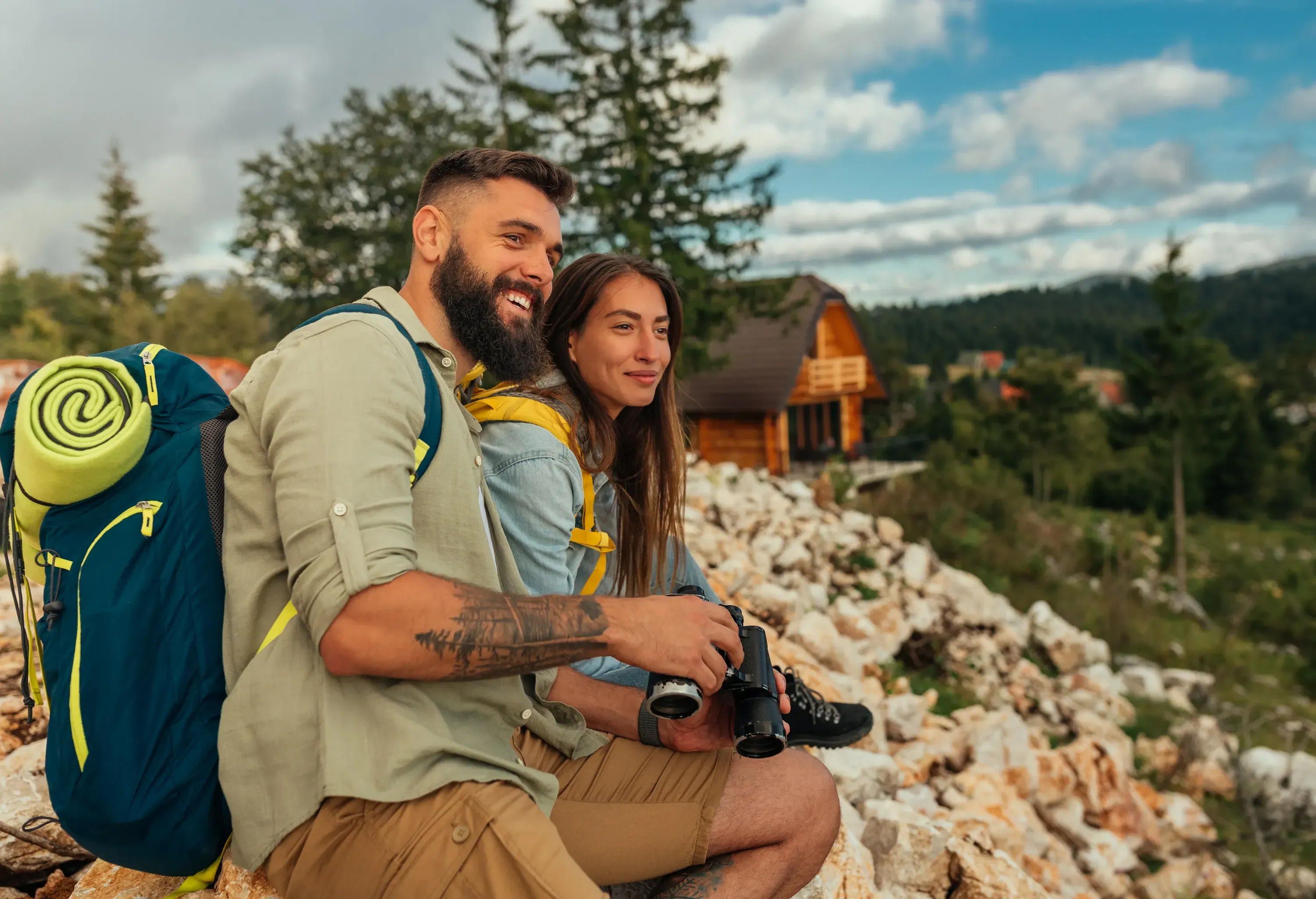 Young hikers sitting on rocks while taking a break