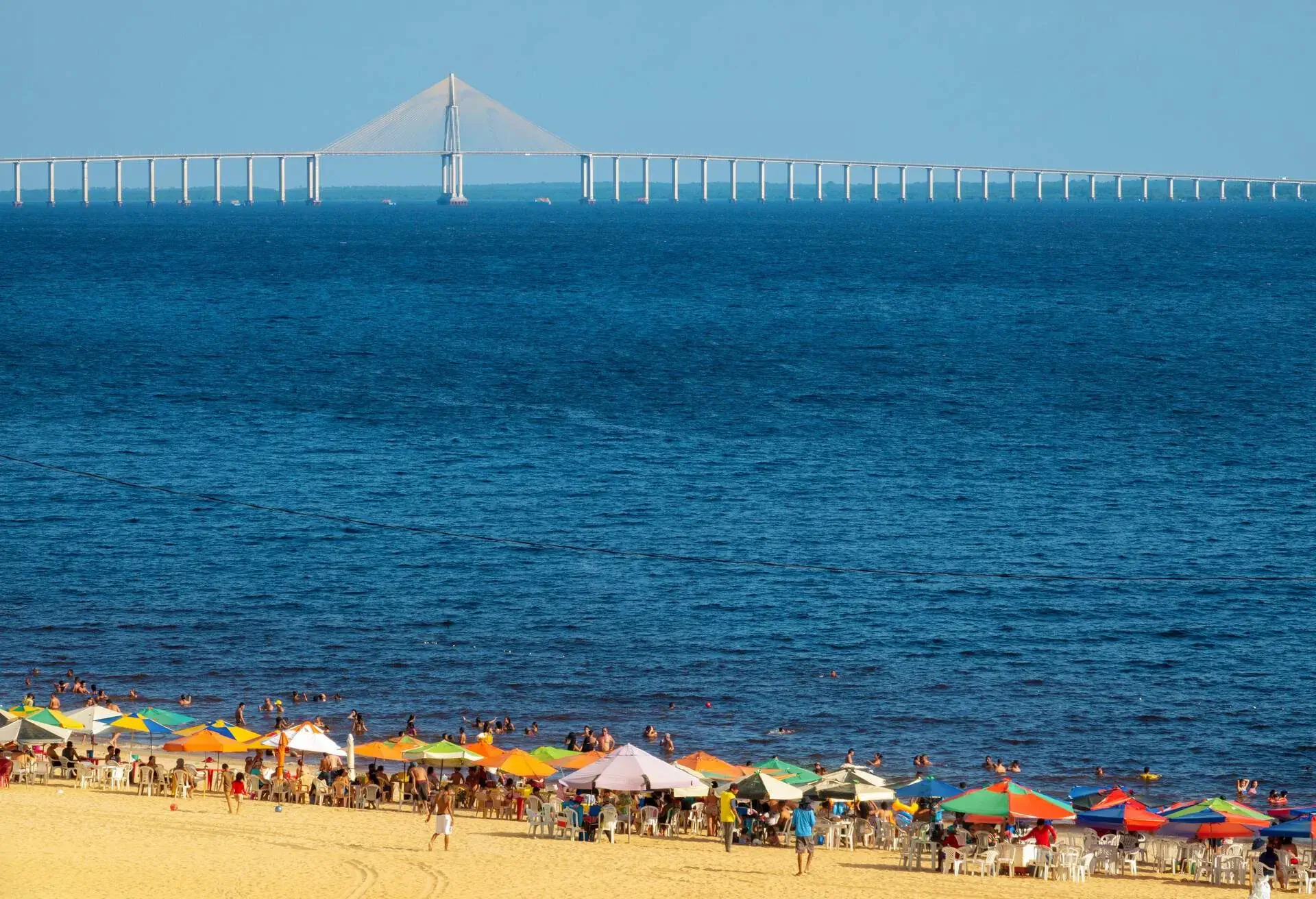 Beach at the border of Negro River.Journalist Phelippe Daou Bridge in the background.Amazon Region.Manaus is capital of the State of Amazonas