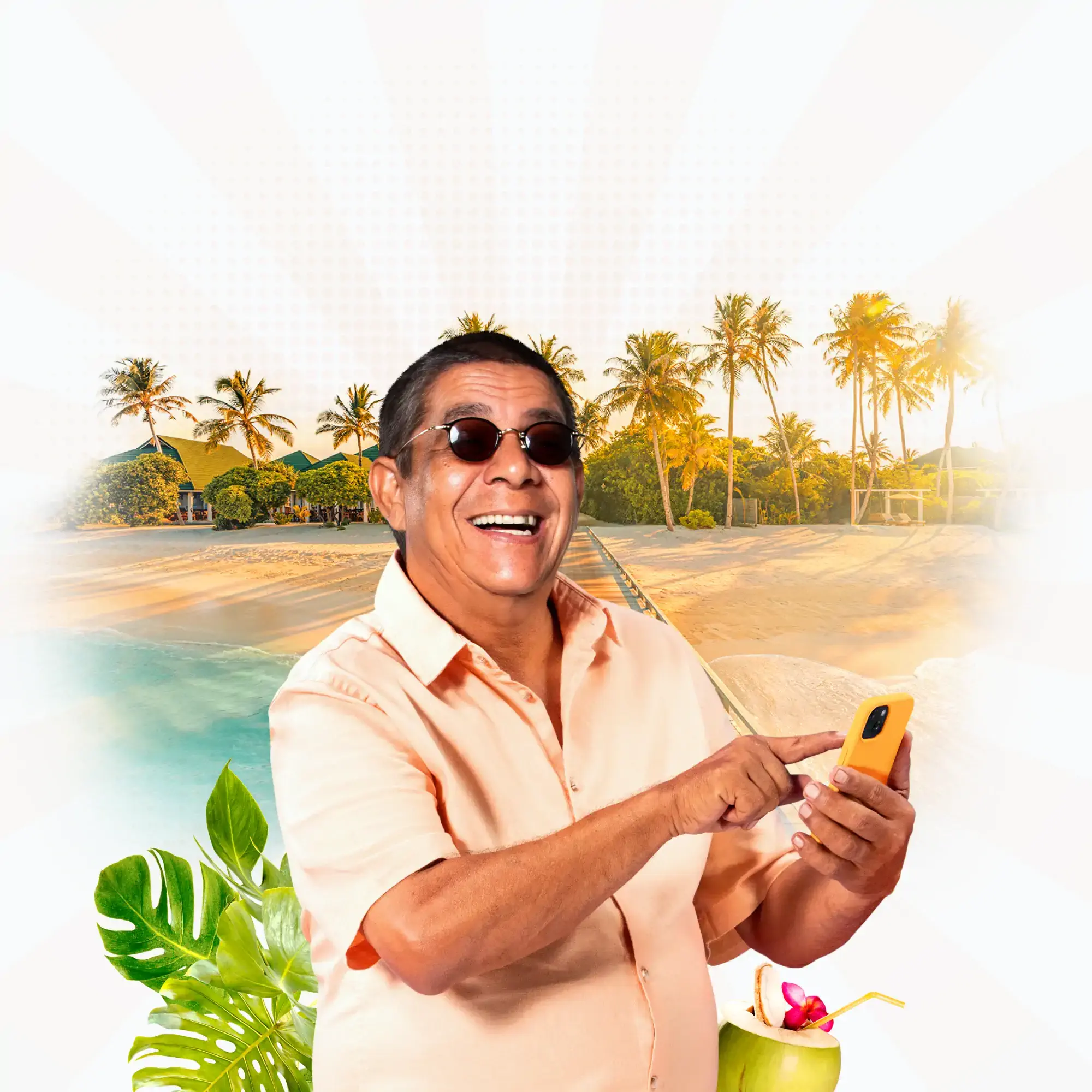 Homem sorridente usando um celular à beira-mar, com coqueiros ao fundo e uma bebida tropical ao lado, em um cenário de praia paradisíaca.
